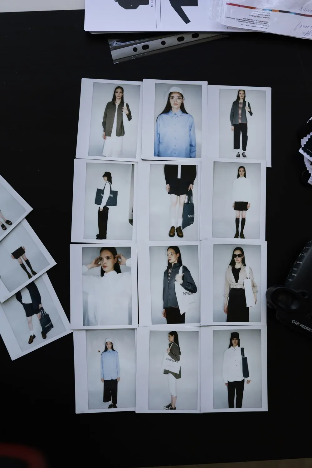 Collection lookbook laid out on a dark wall