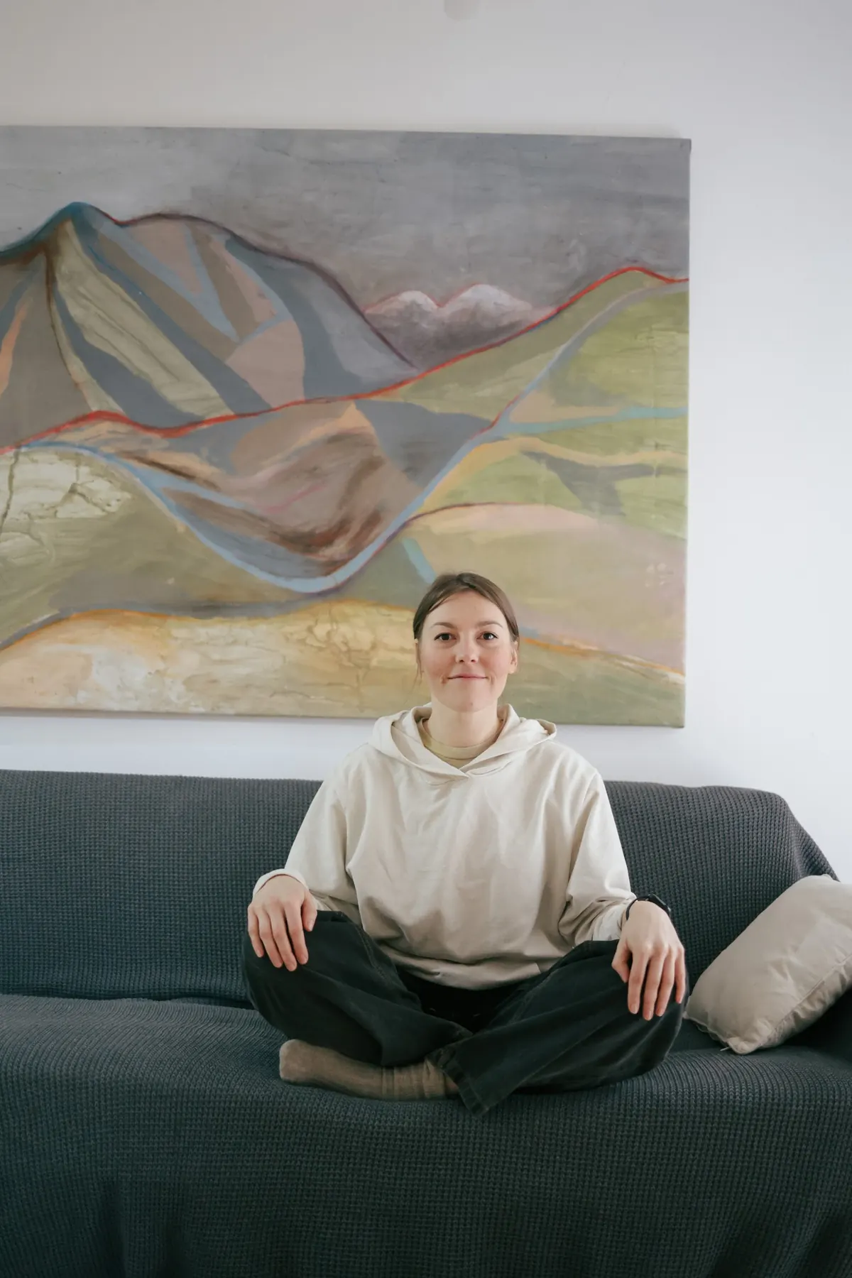 The artist seated in front of the work