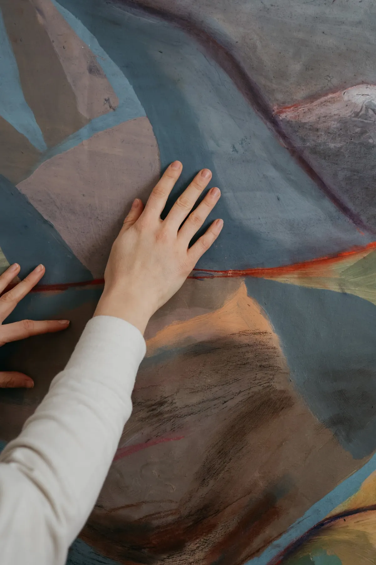 Detail of the painted landscape, hand across the surface