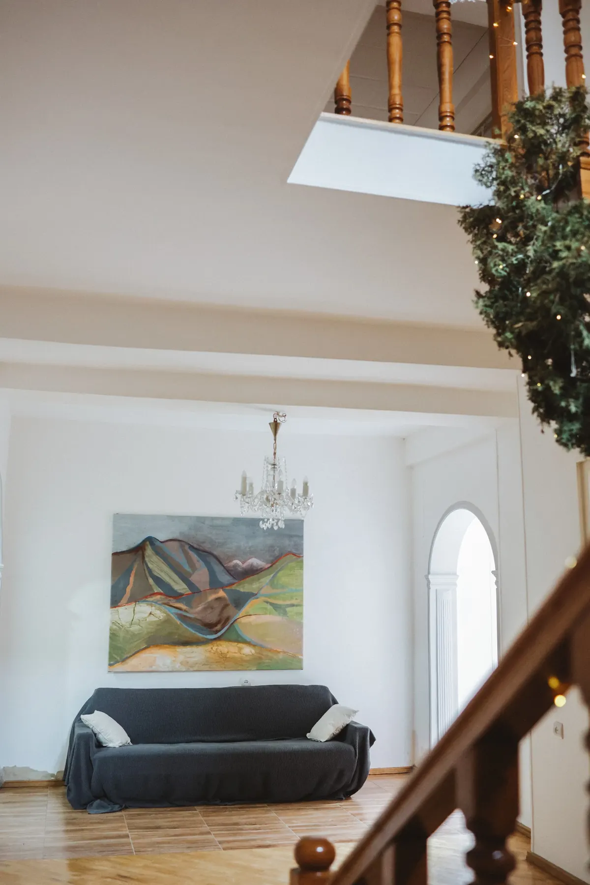 A large landscape work hung in an interior