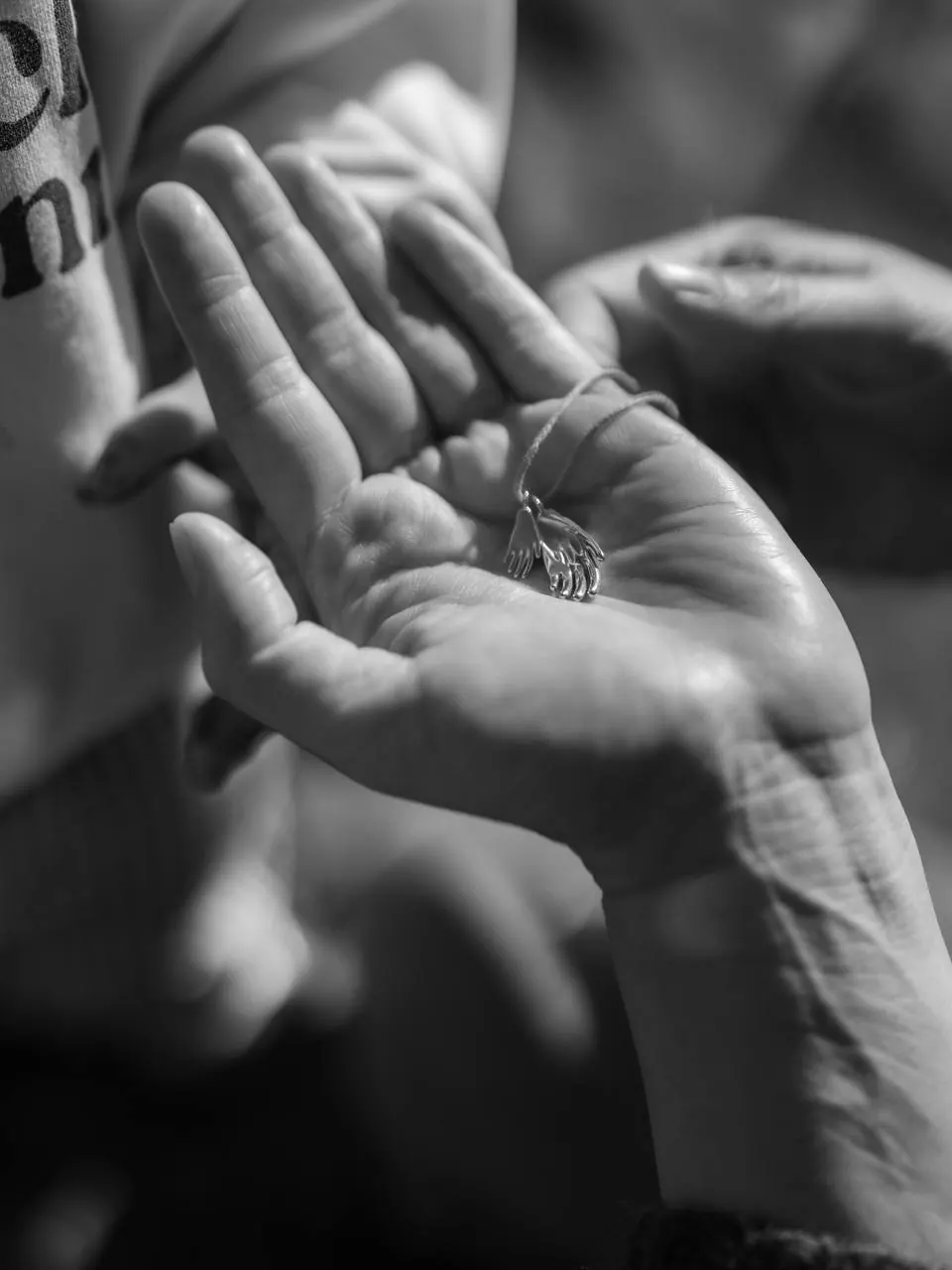 The pendant held in an open hand